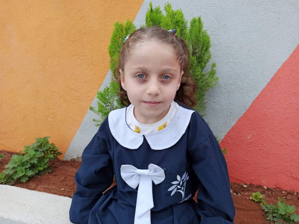 Aya now has friends and goes to her class every day, carrying her books and aspiring to become a doctor.