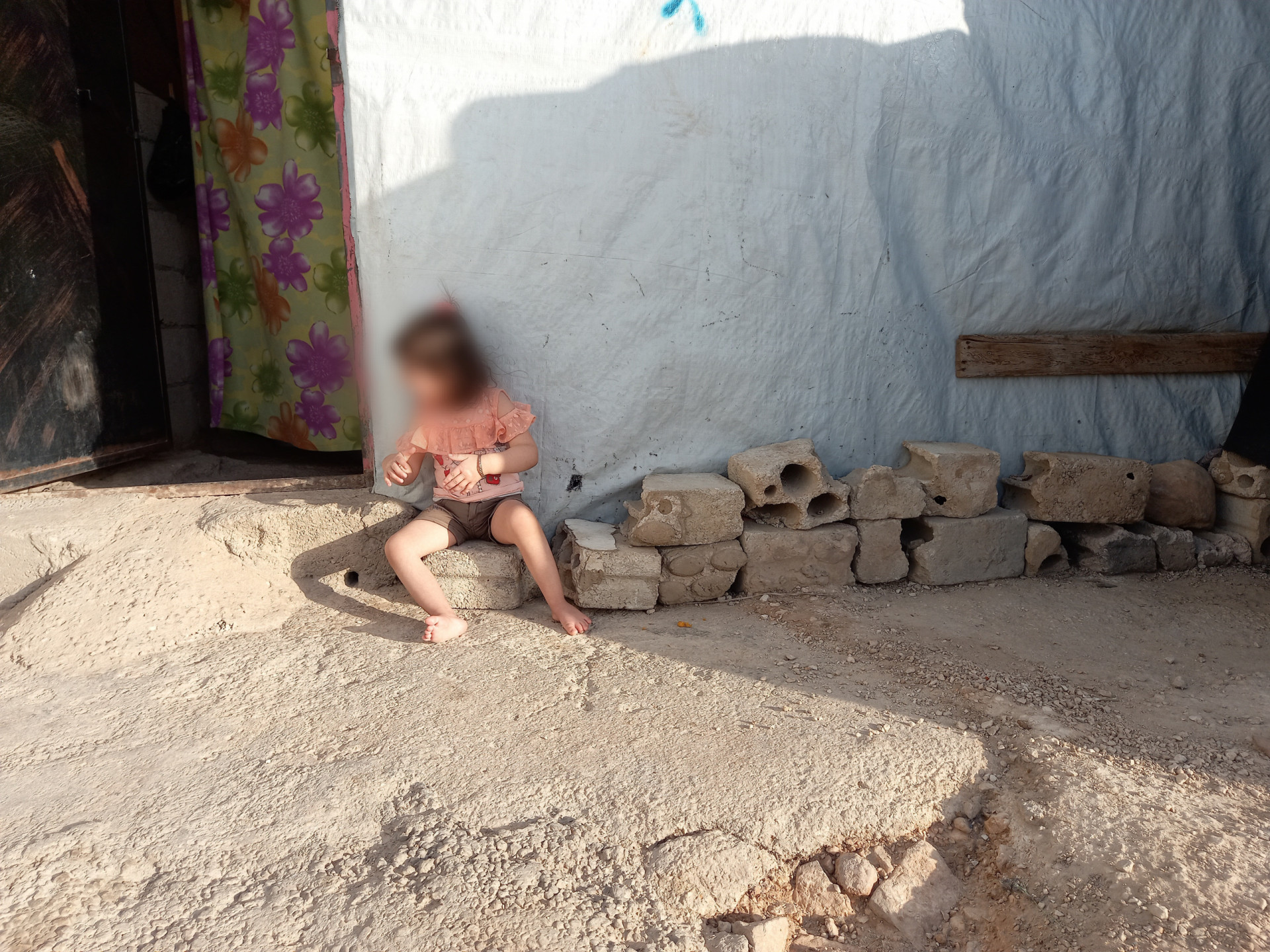 Nagham and her family stand with no provider