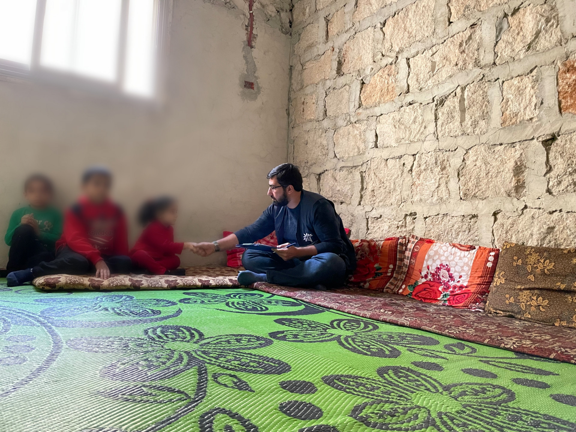 A widowed woman stands alone with her children