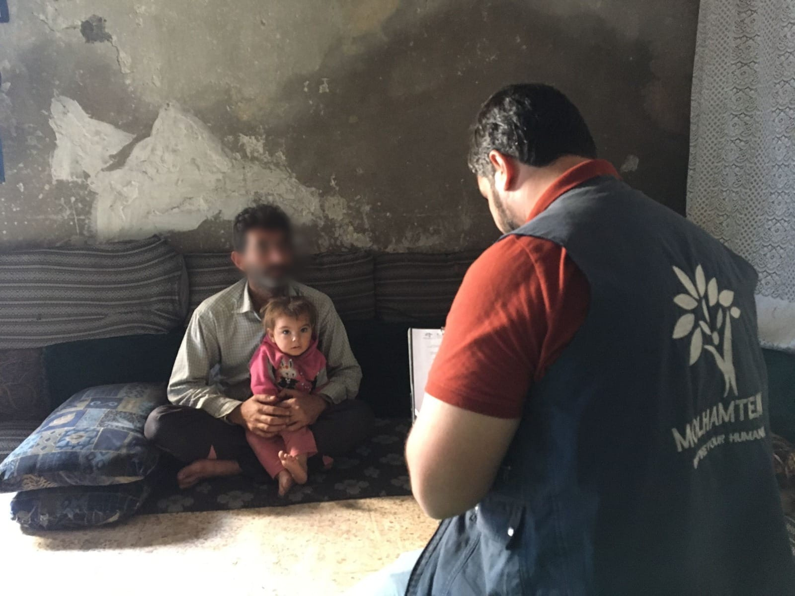 A family lives in a simple house that lacks minimum essentials of life