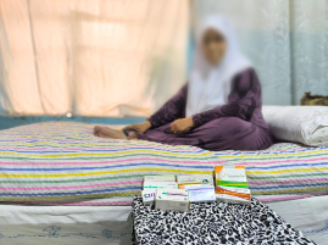 Lutfiya, a mother exhausted by illness and grieve.
