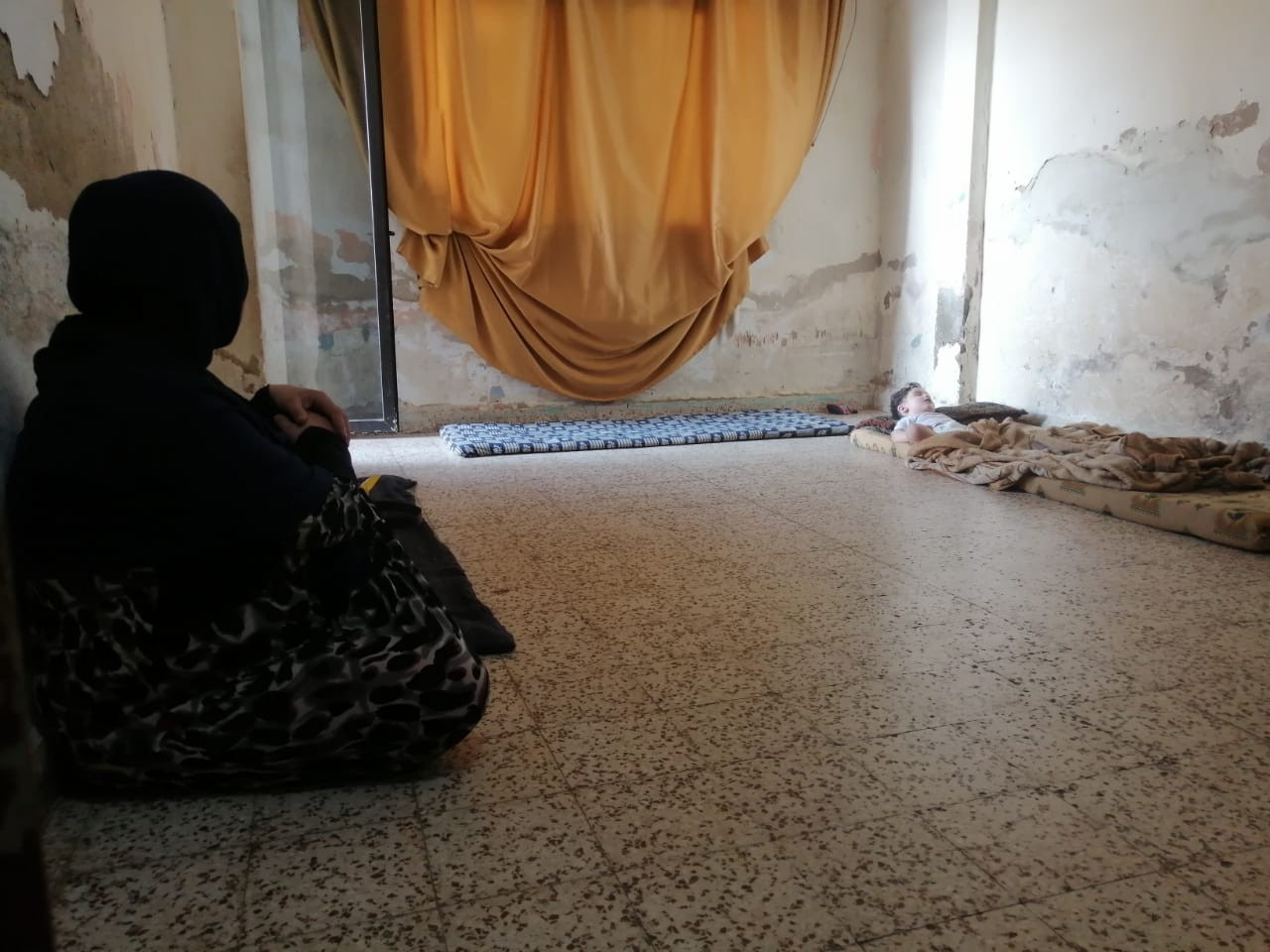 A mother lives in difficult conditions with her children in the camp