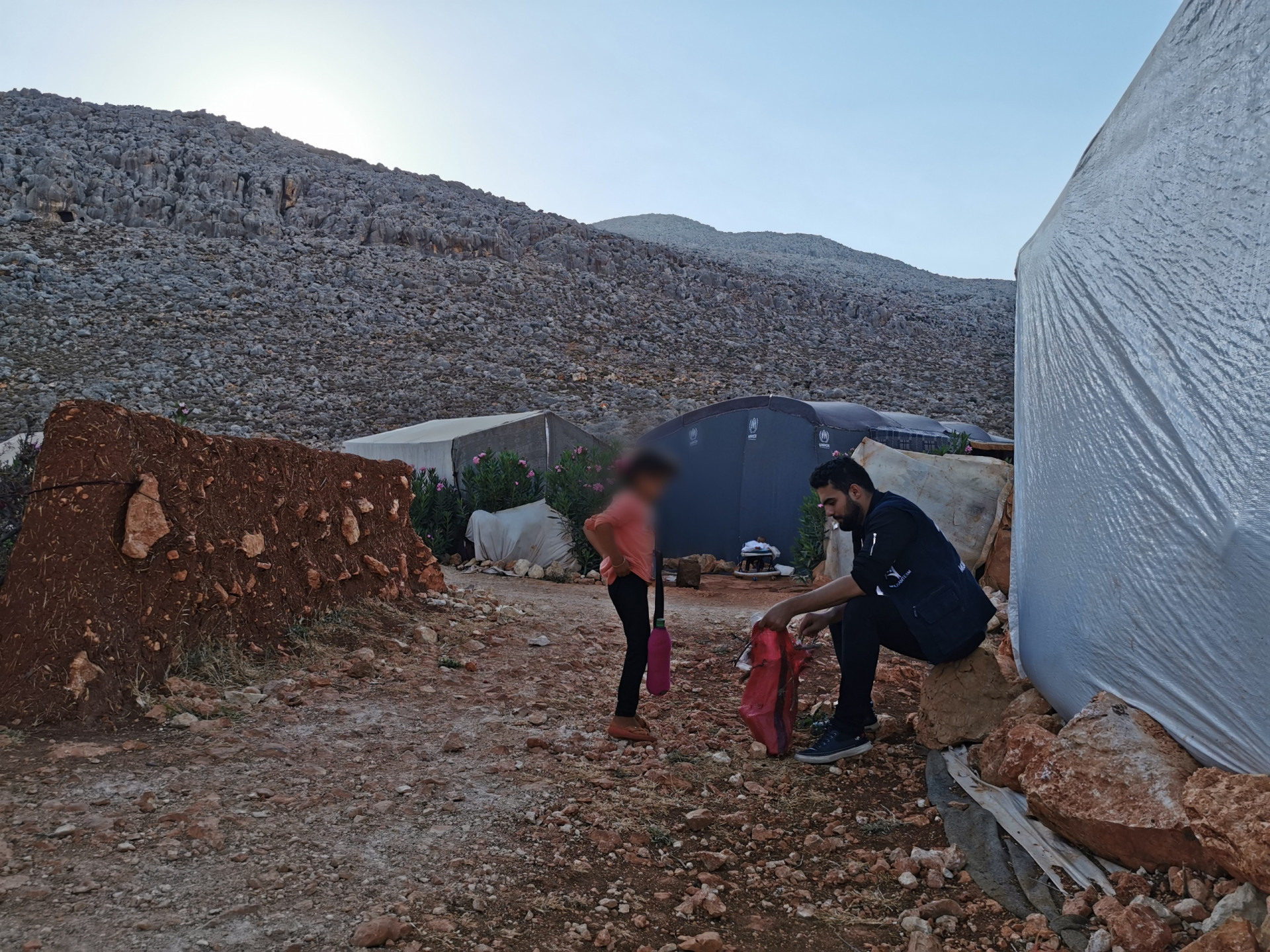 A family that have orphans and a handicapped kid live in a tent