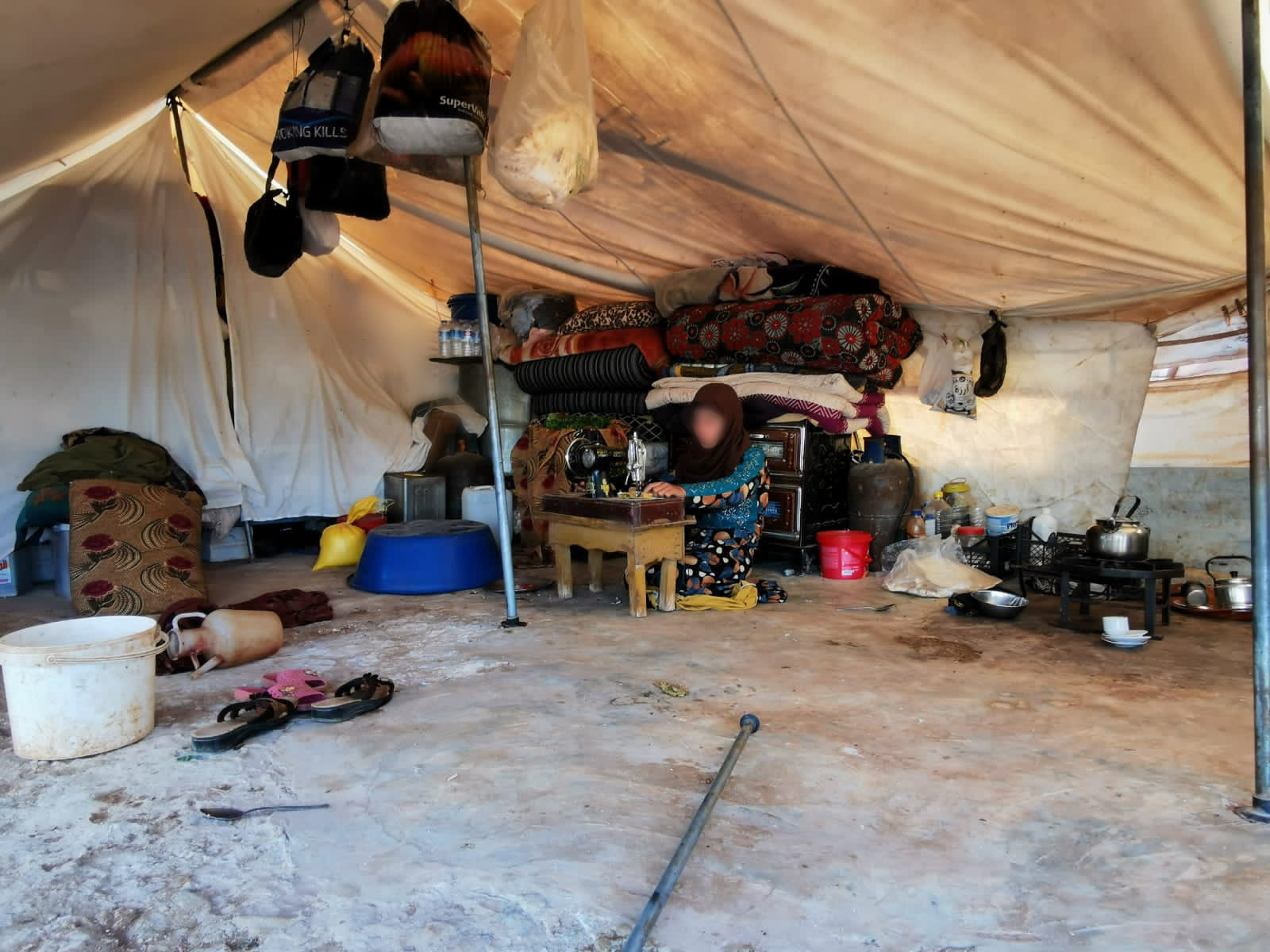 Three families live together in a small tent.