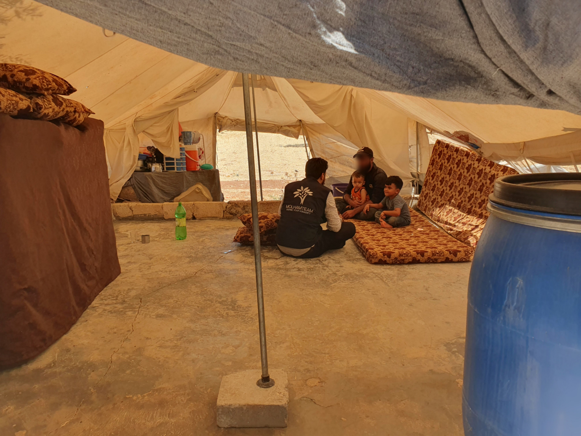 Nour's family lives in an unserviced tent, enduring the high temperatures.