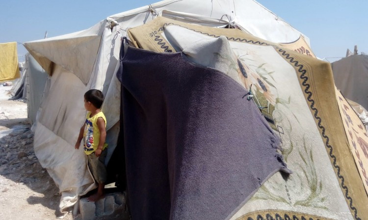 A widow and her kids have no support and live in a small tent.