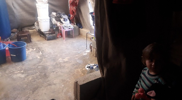 Family living in an inhabitable tent