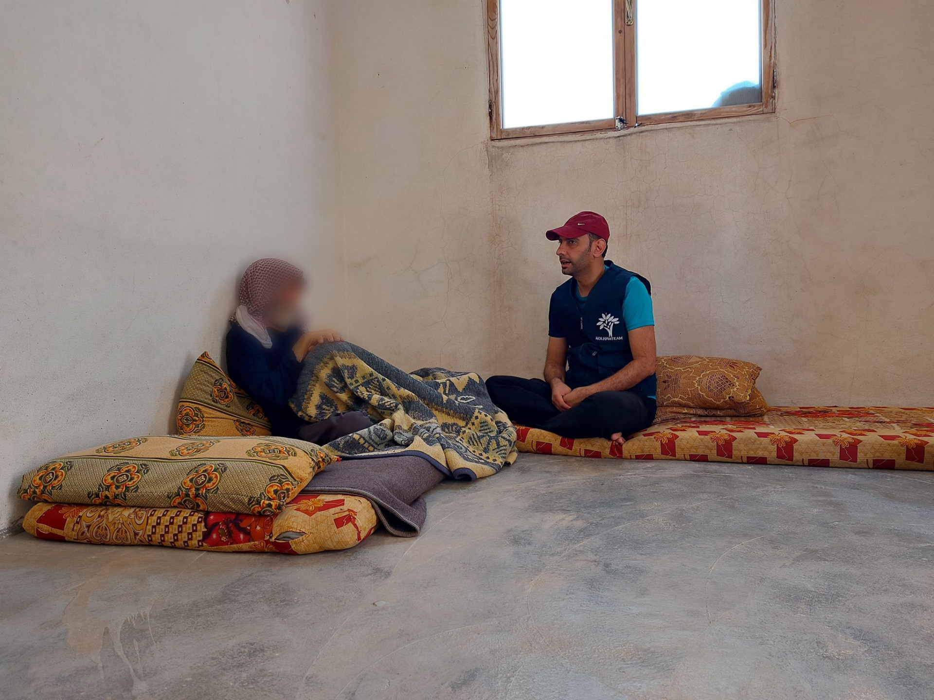 Amina and her husband live in a small room without electricity