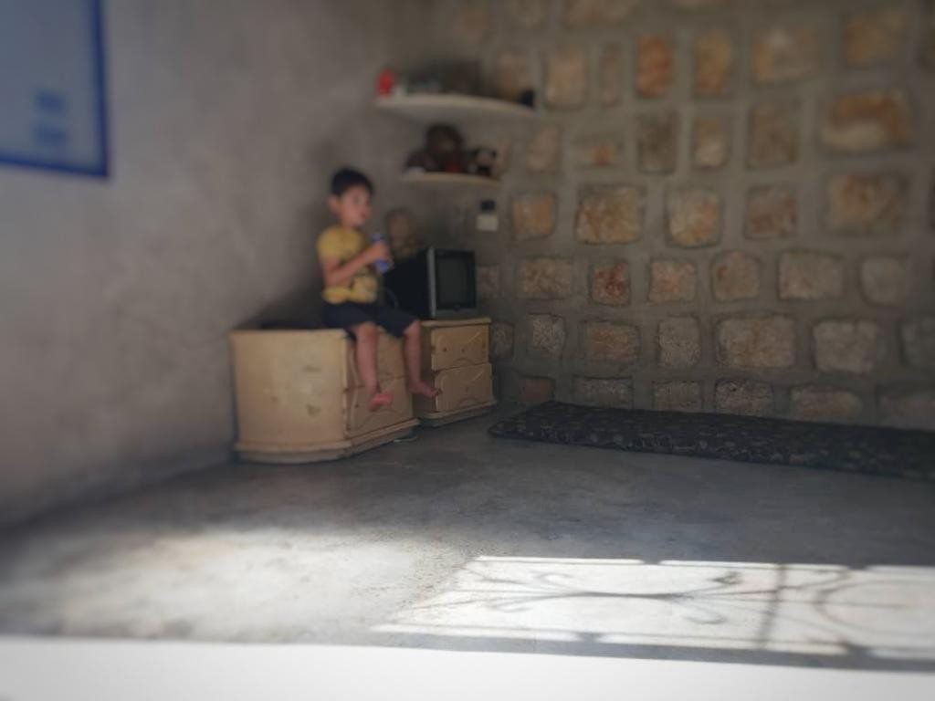 A displaced family lives in one room