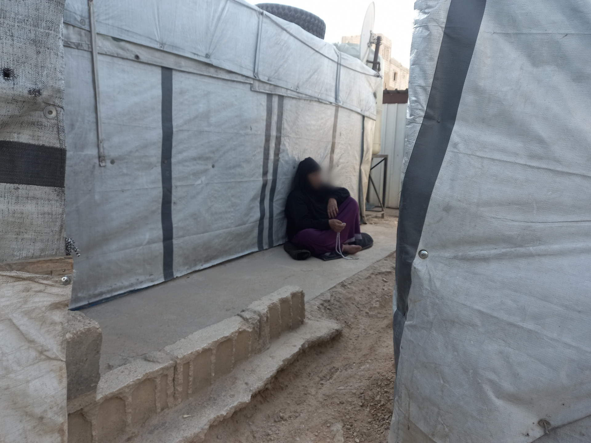 Nazha, stands alone with her pains.