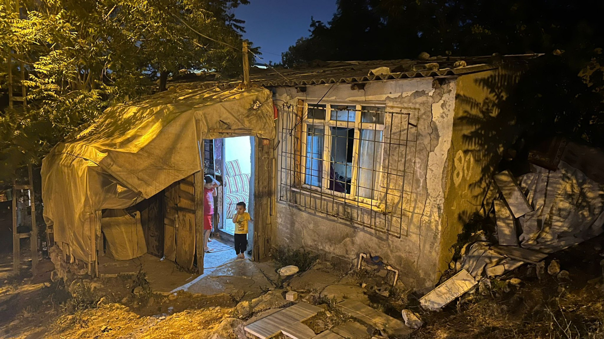 In an isolated, semi-abandoned house, it's hard to imagine that it's a shelter for a family awaiting relief.