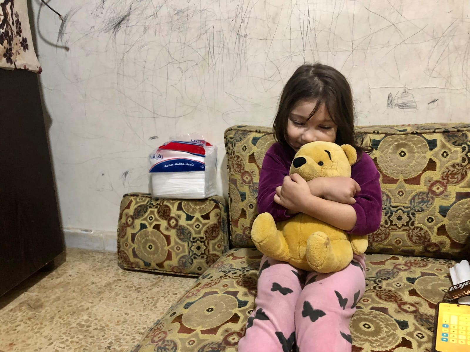 Who saves Amira and her mother from the cold of winter?