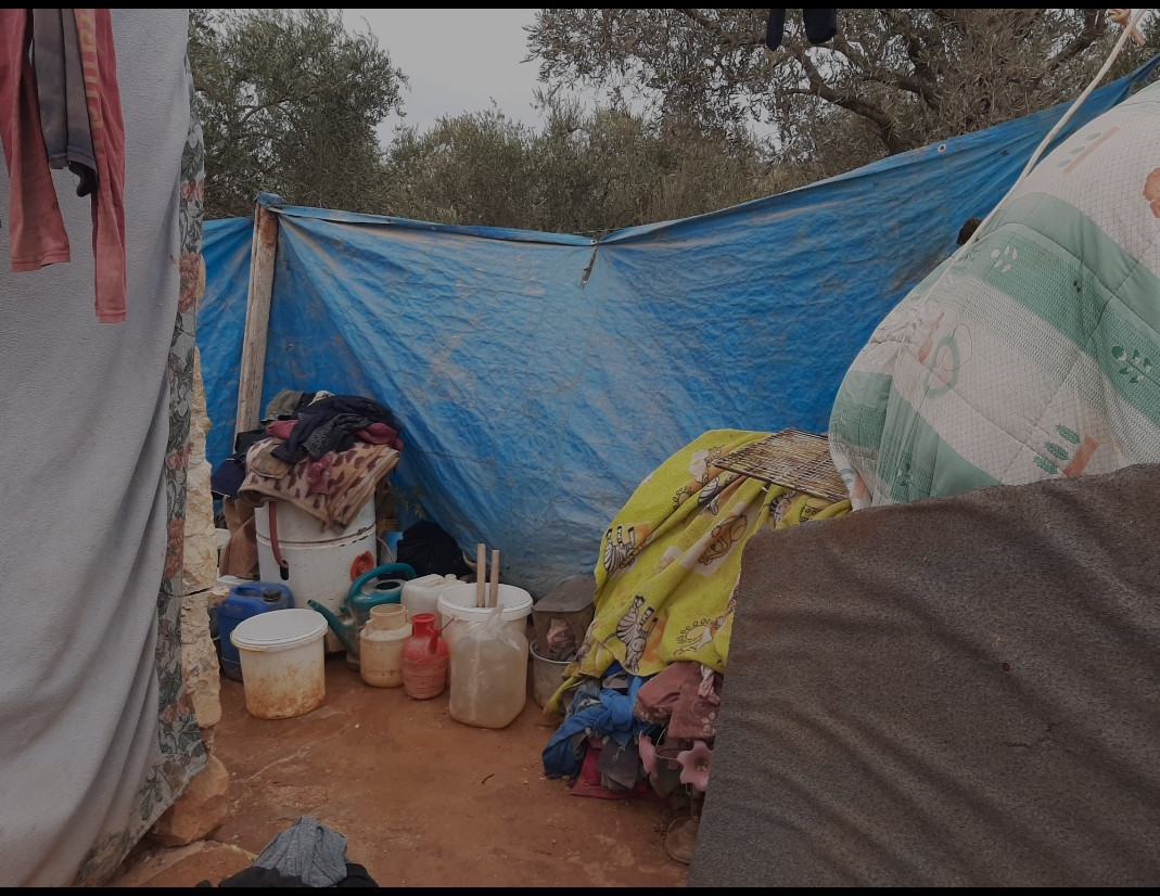 The dilapidated tent of Ahmad's family has sunk in the mud