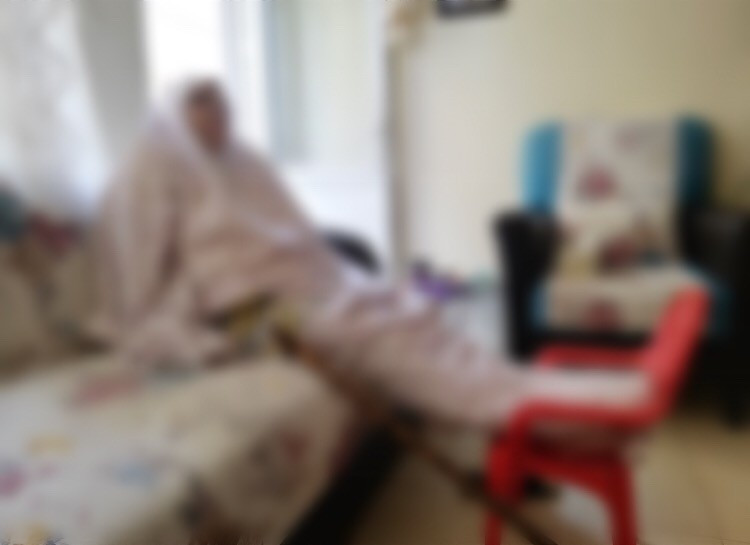 an old lady is suffering and in need for an automatic wheelchair