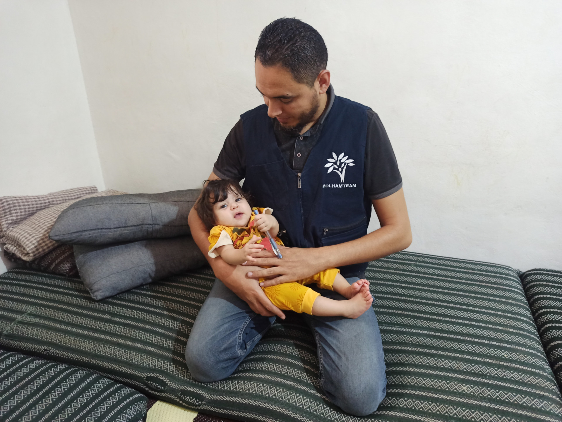 The child was born with delayed motor development due to cerebral atrophy.