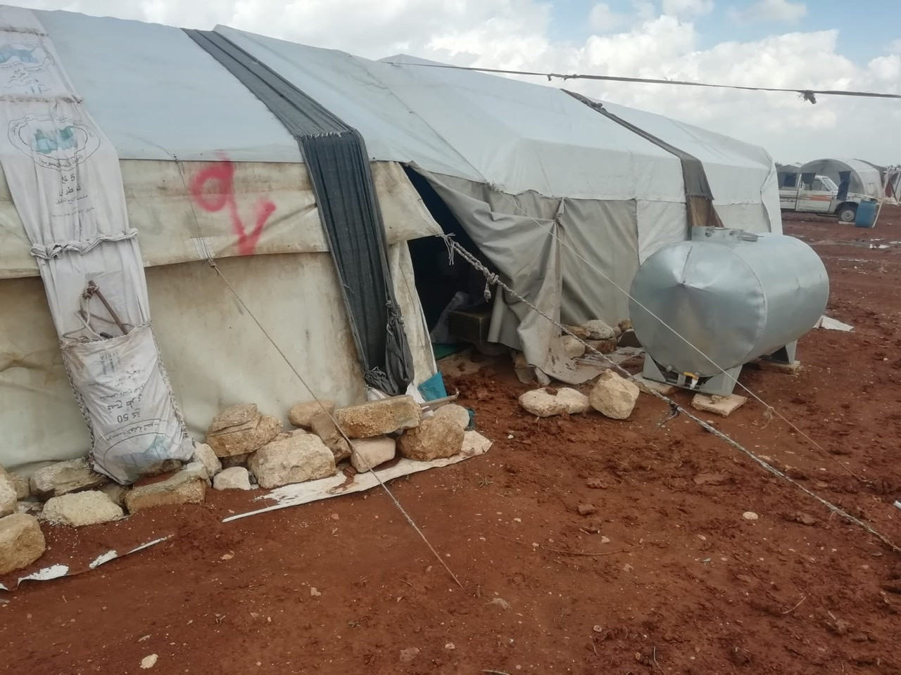A family of eight people live in a small tent!