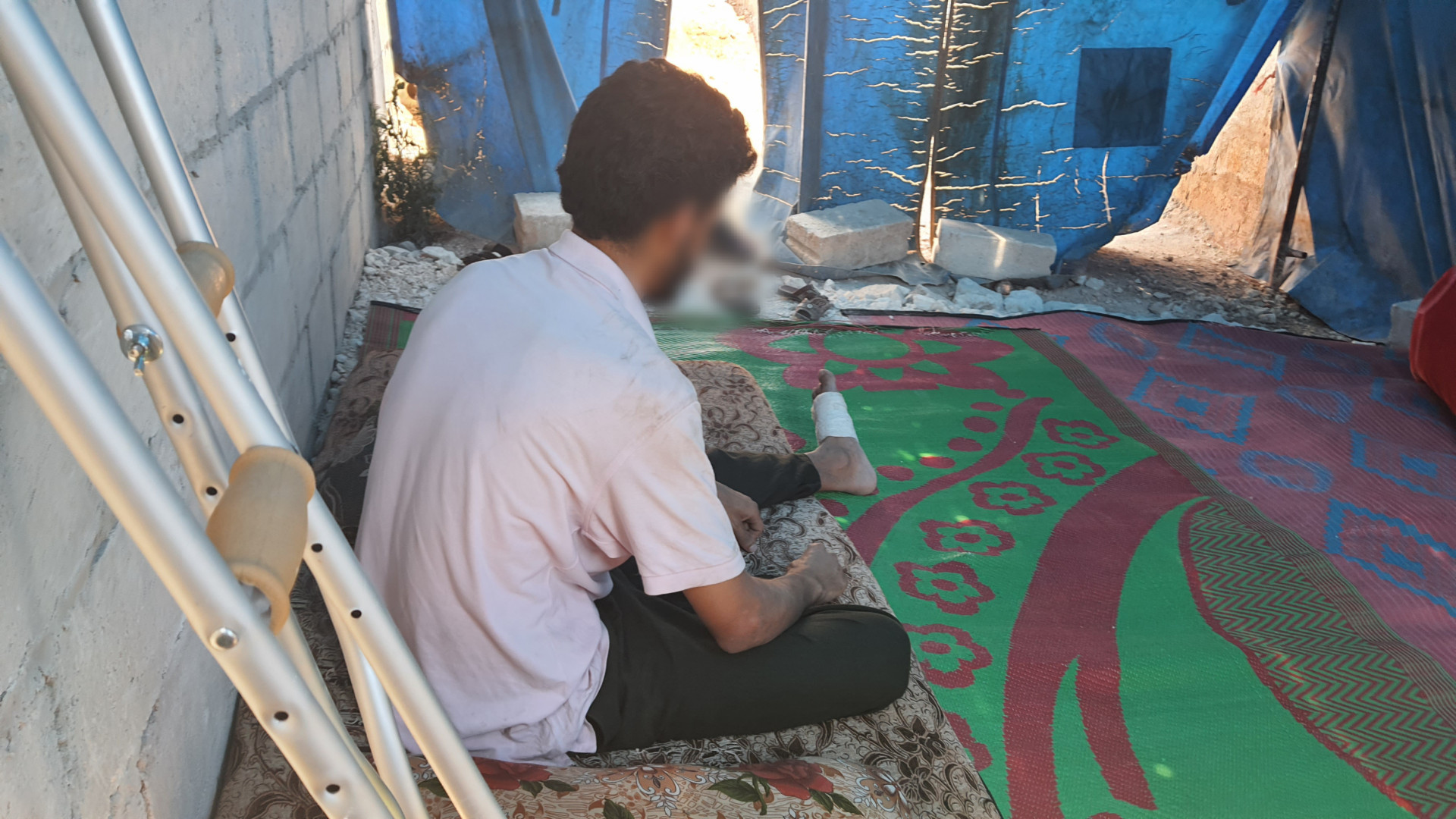 Mahmoud was injured by shrapnel in his back and he needs surgery