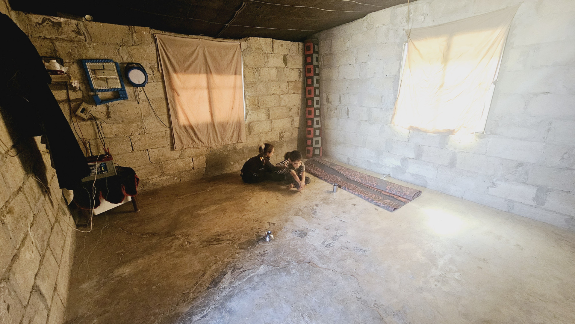 In a ceil-less tent, lacking the basic living needs...