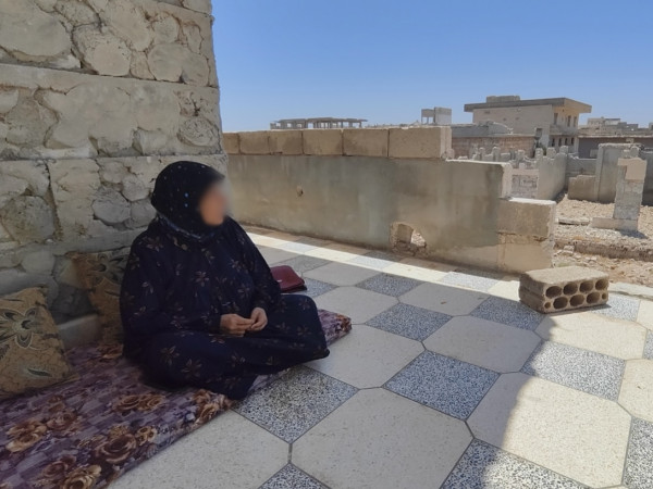 A widow struggling amidst the rubble.