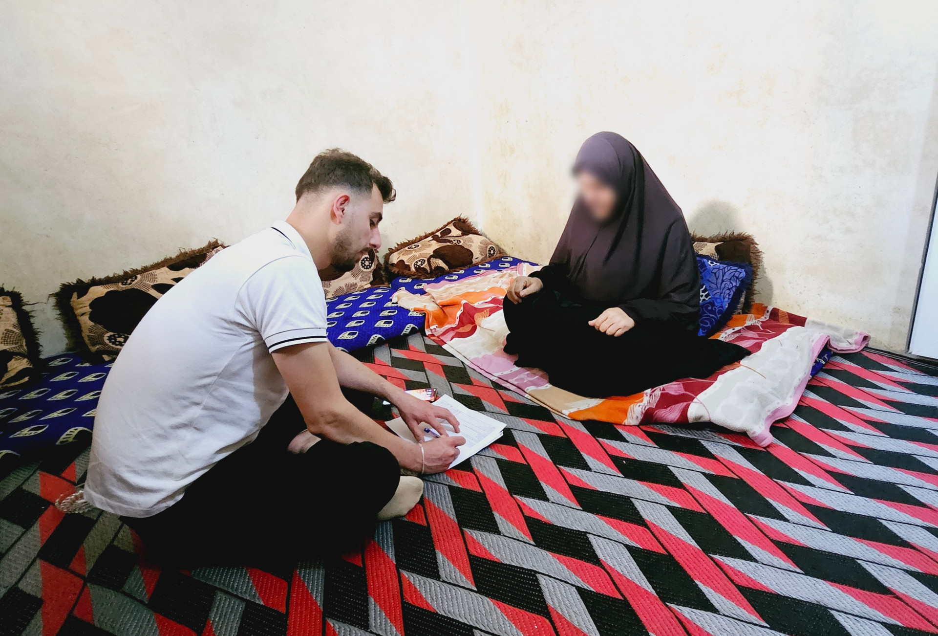 Ruqaya is waiting for someone to comfort her and her grandchildren.