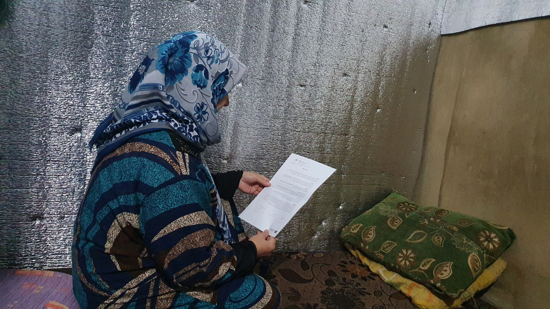 Zainab stands alone in a tent, needs urgent surgery