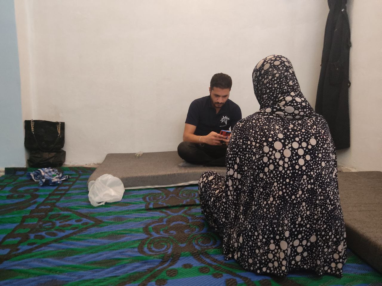 A displaced widow exhausted by debt