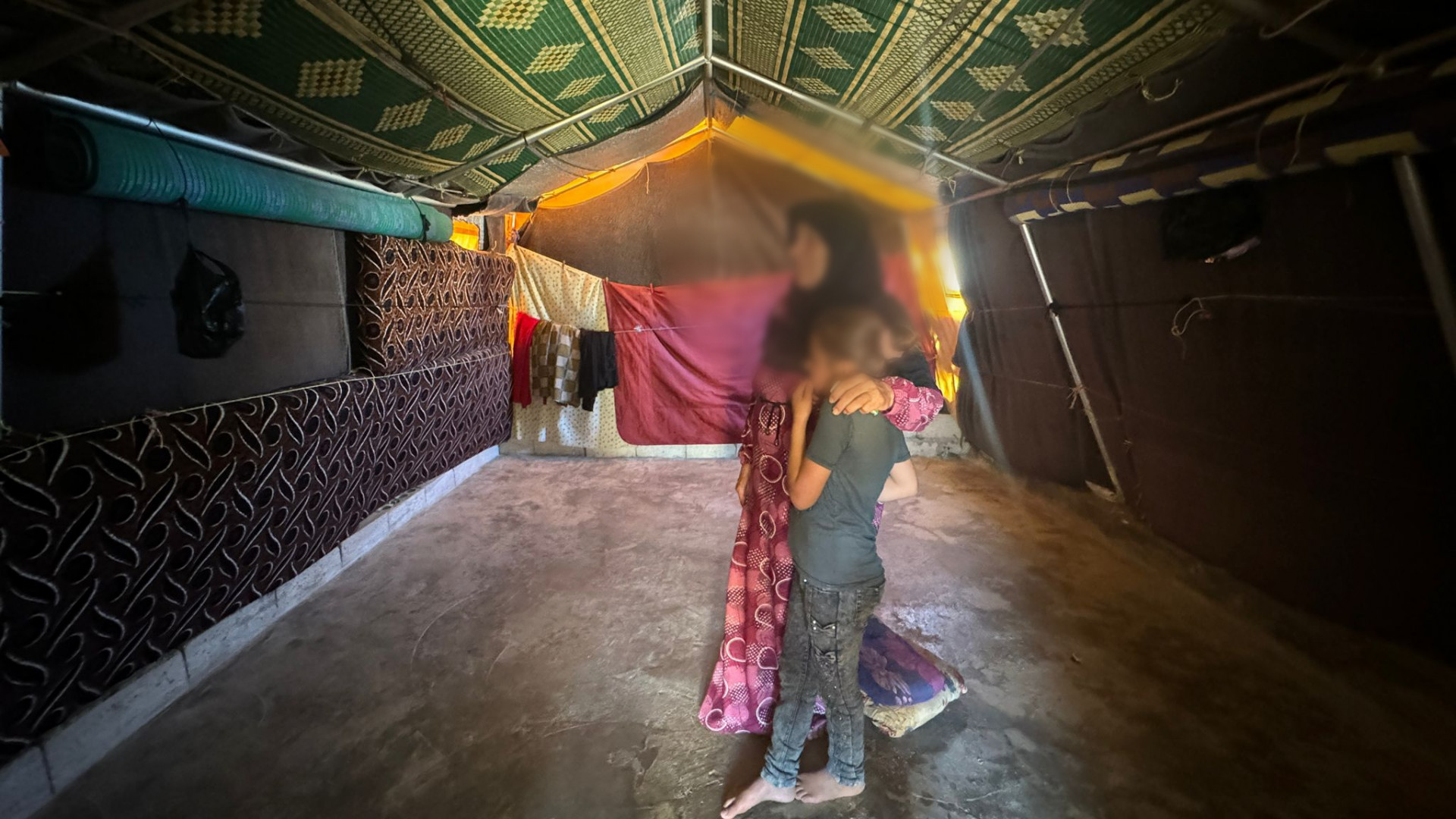 In a Dark Tent, a Family is Waiting For Help