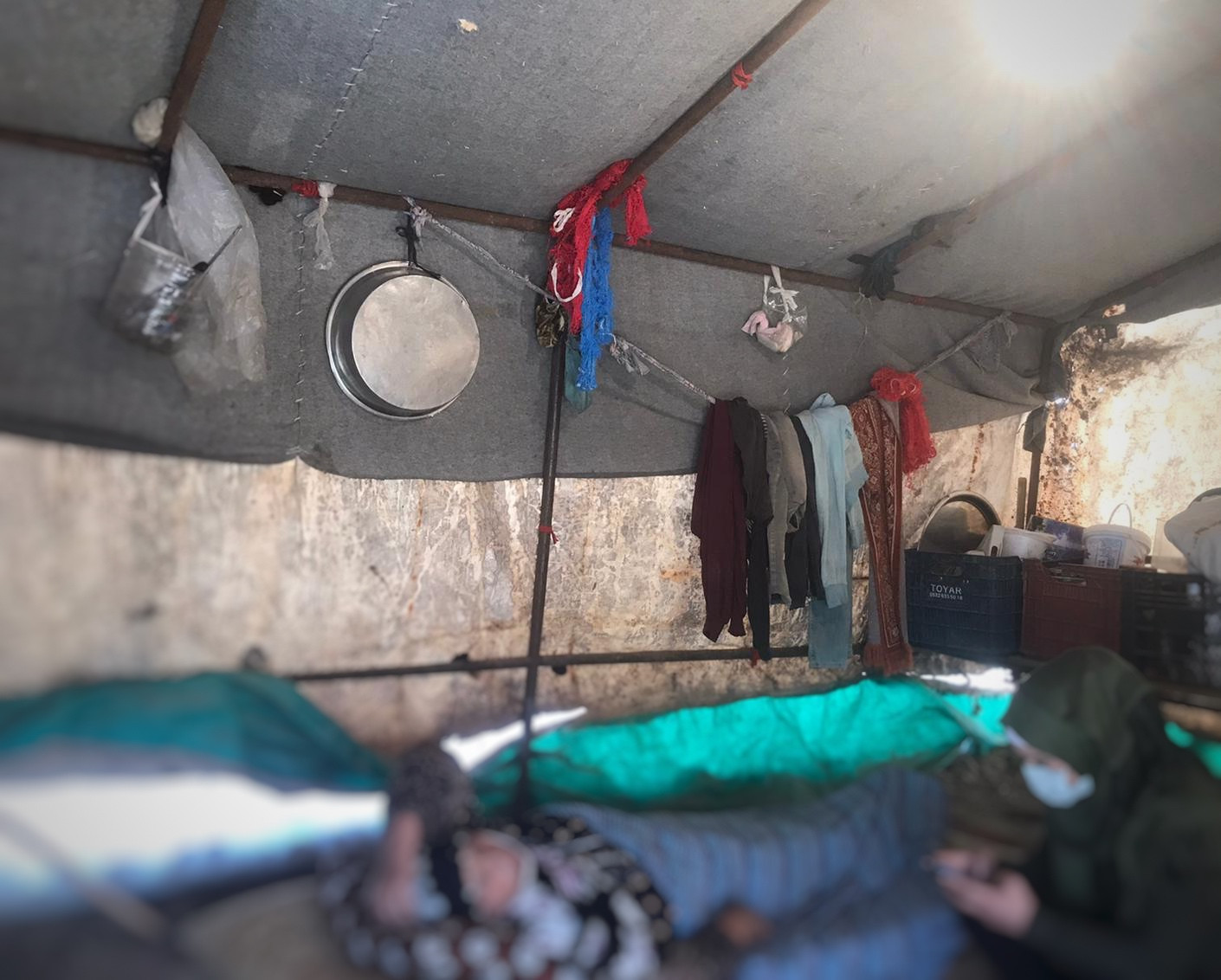 A cancer patient faces terrible living conditions in a tent.