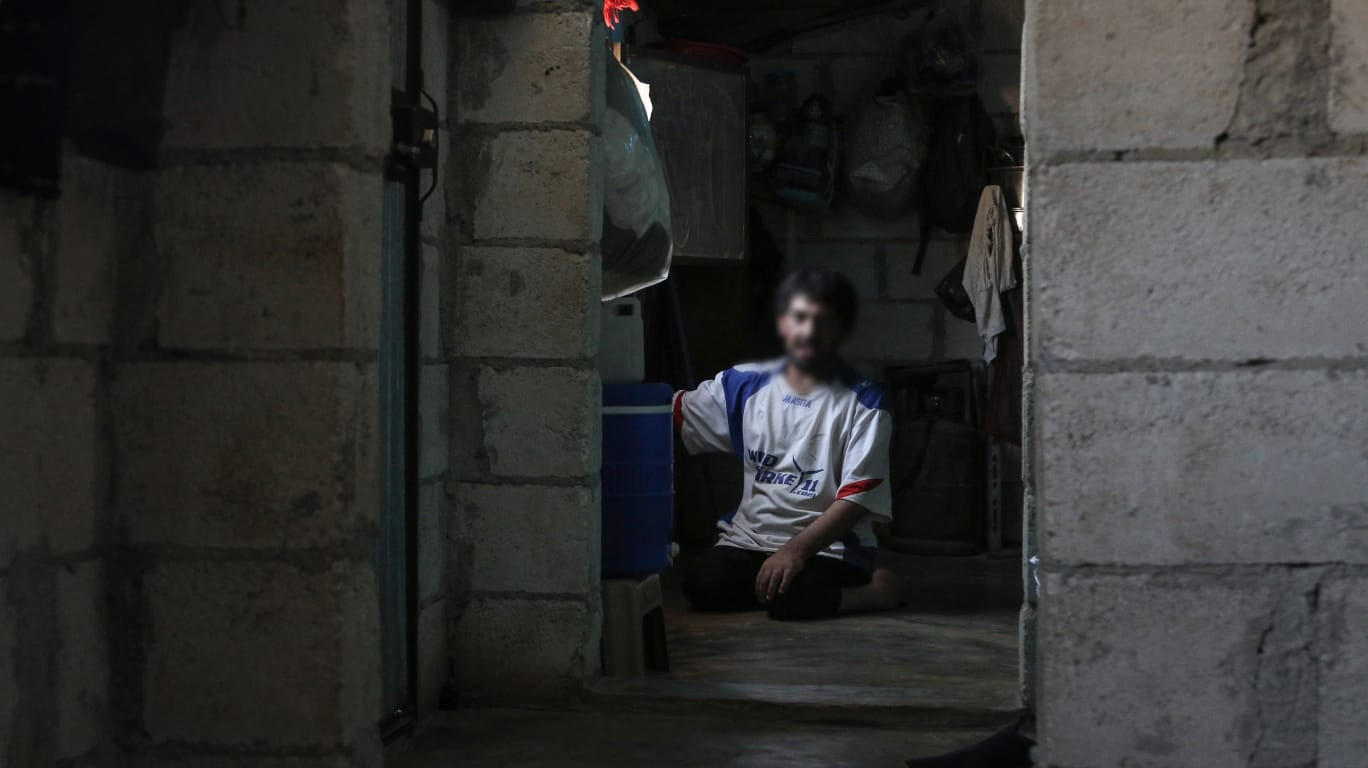 A family exhausted by illness, is staying in a tent under dire humanitarian conditions.