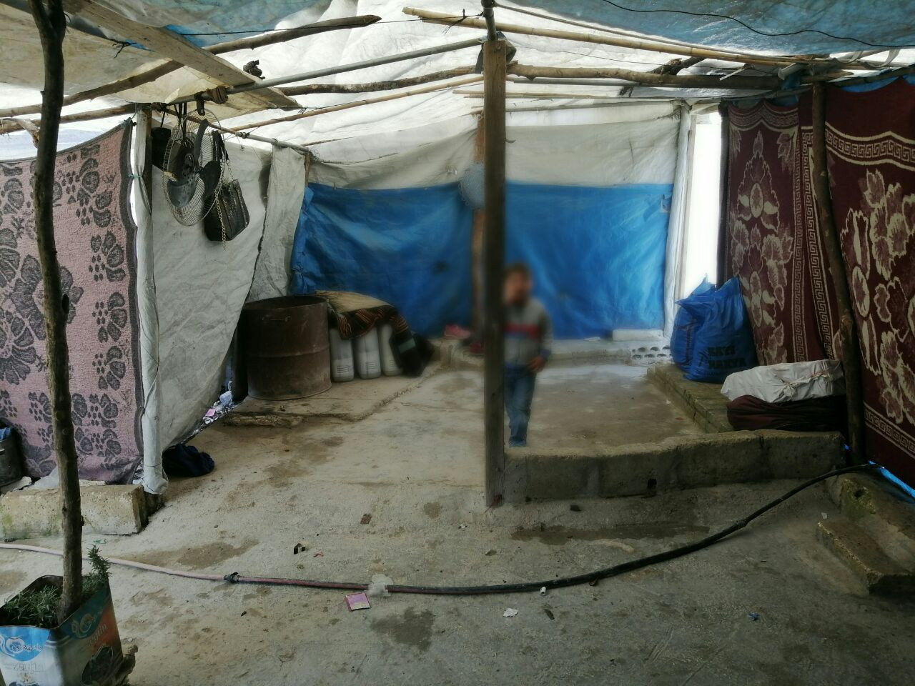 They live in a torn tent, they lack warm resources