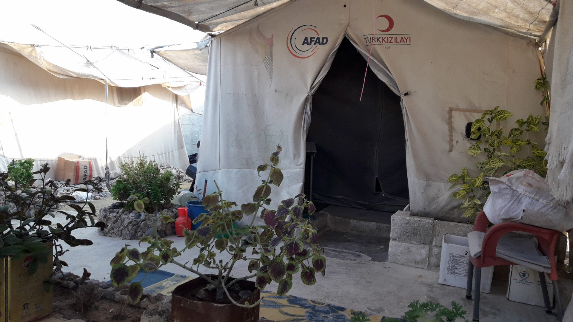 A lady waiting for her child in a tent!