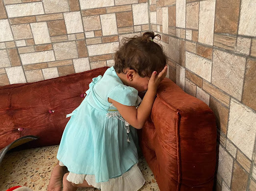 A little girl with a hearing impairment needs a hearing aid