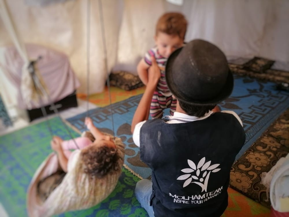 Two children living in a poor tent with their family having no income need your help.