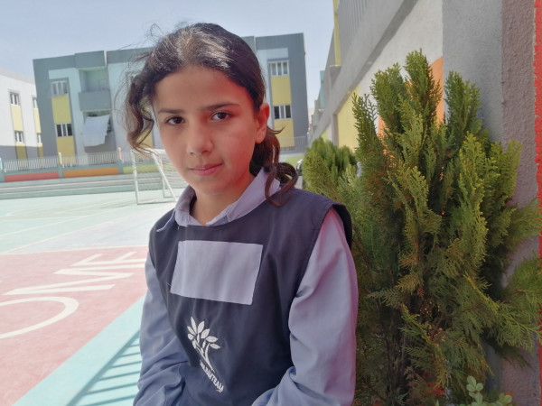 Rahaf, a young girl with childlike features, lives with her sisters.
