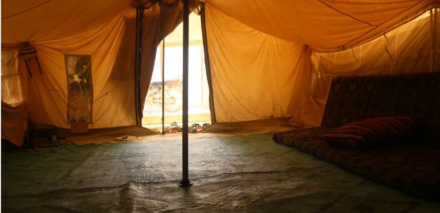 An elderly woman lives in a tent!