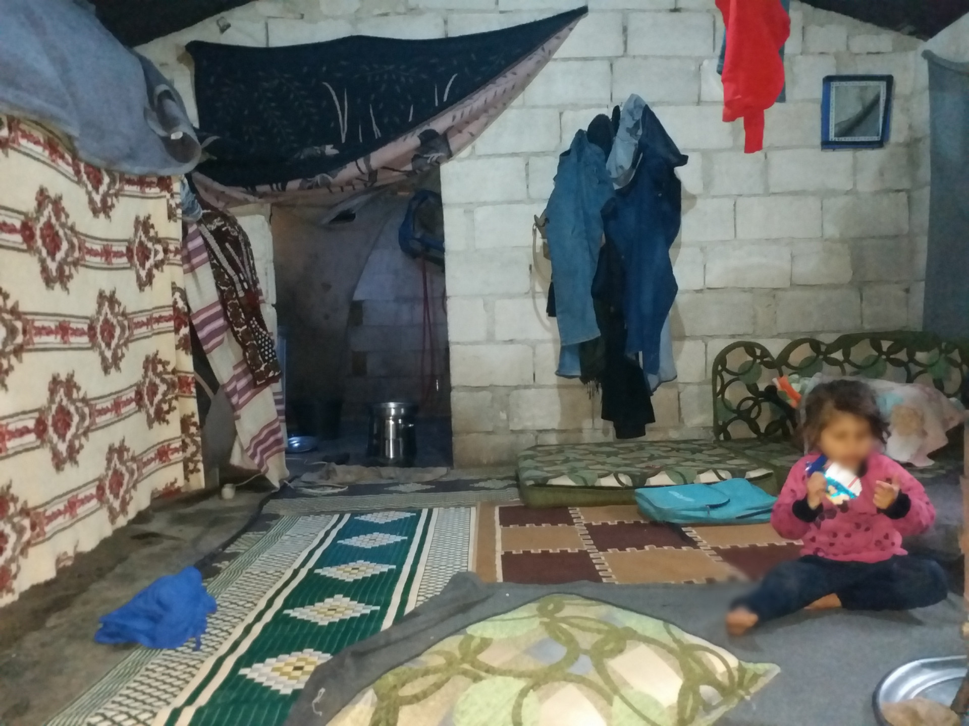 The family lives in a worn out tent in difficult living conditions