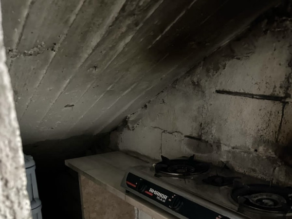 A family living a semi-life under the stairs