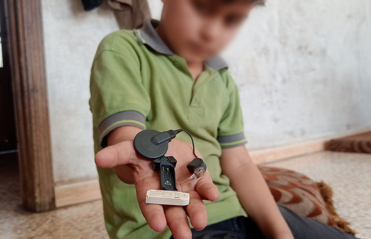 Young child lost his hearing due to war and needs a battery for his hearing aid