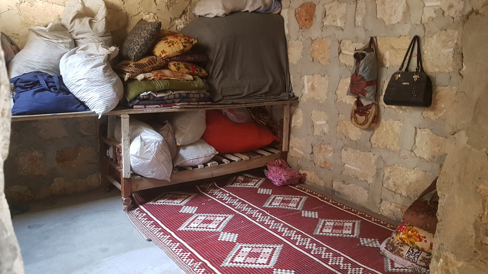 A family lives in a partially destroyed house