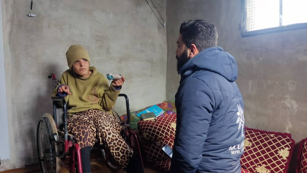 A family lives in a small tent with a child suffering from cerebral atrophy.