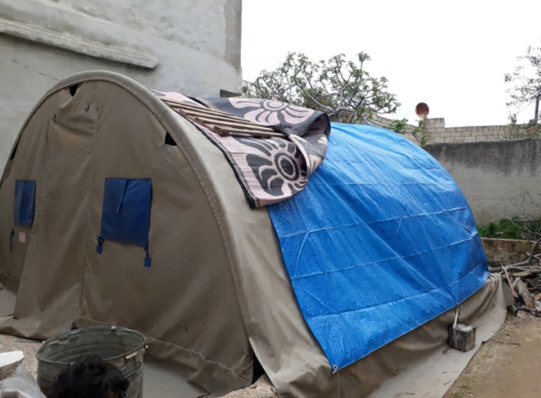 A family lives in a room and a tent!