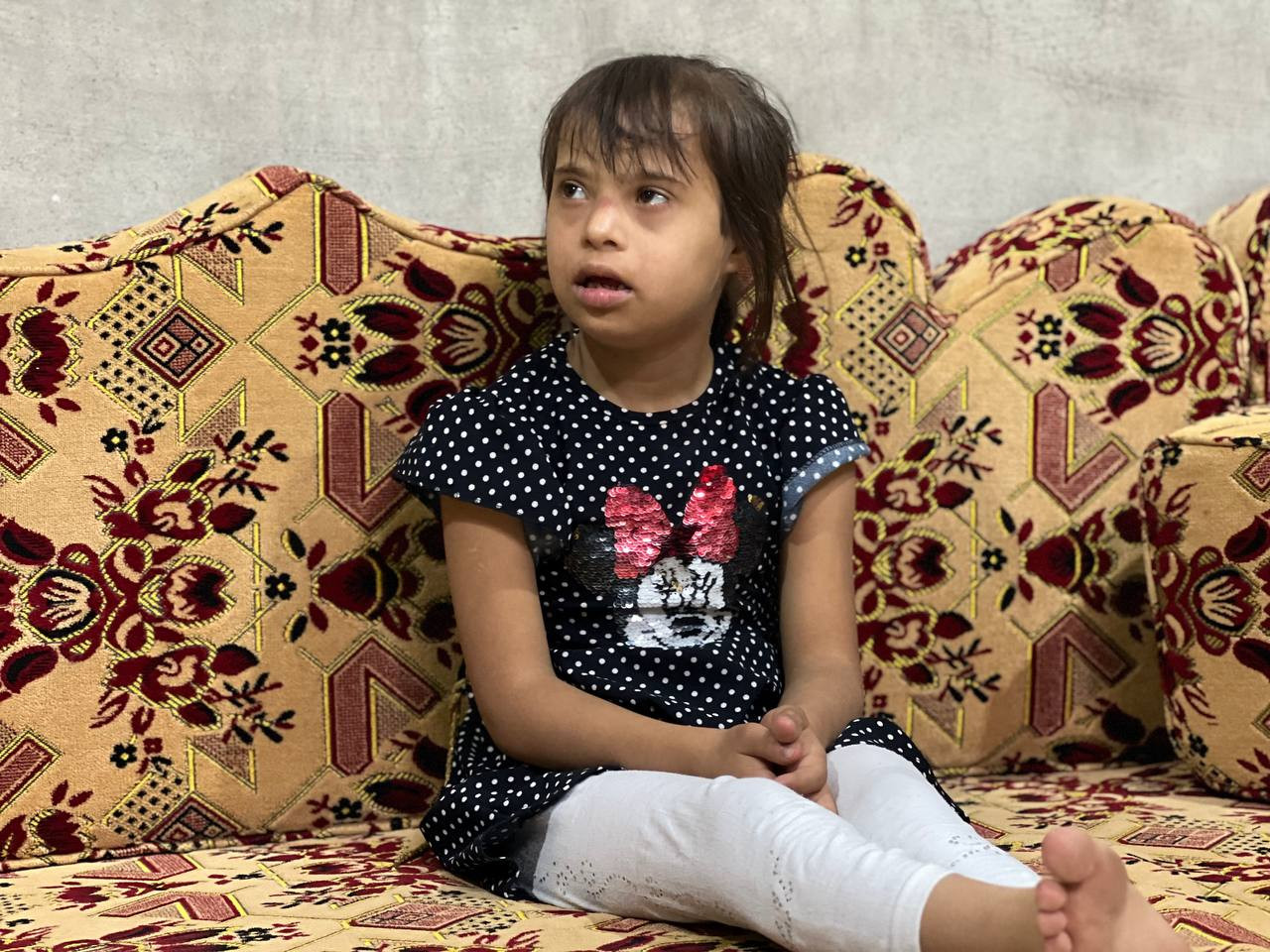A young girl suffering from Down syndrome and multiple other illnesses