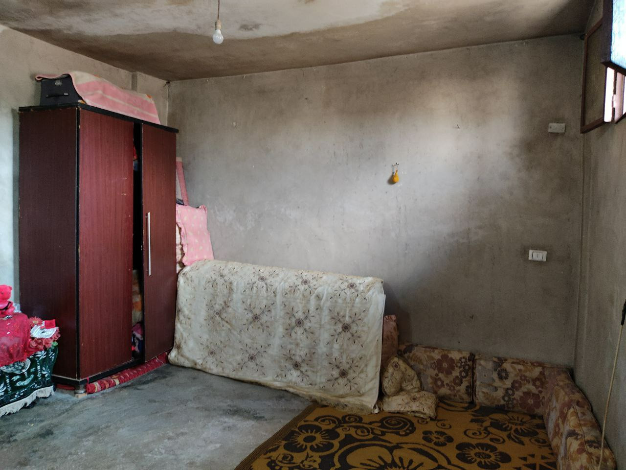 A displaced family lives in a room lacks all basics
